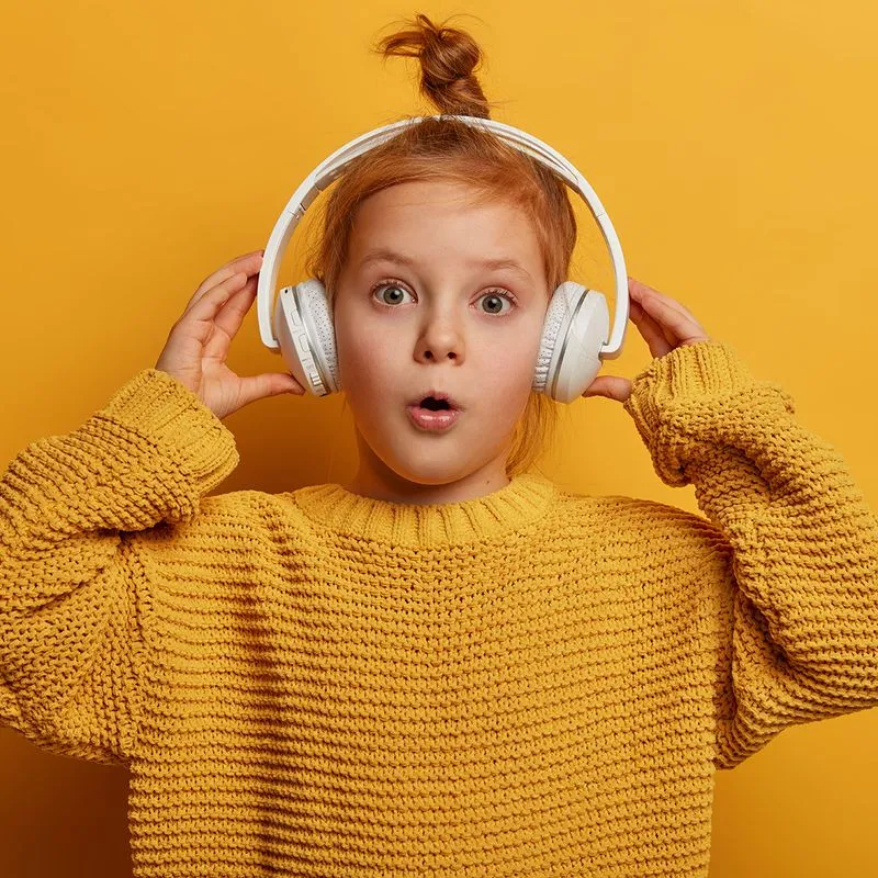 Mädchen mit Kopfhörern lauscht einem HEAROOZ Branded Podcast